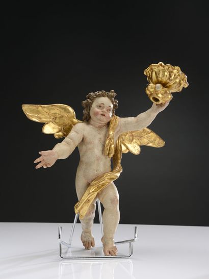 null Pair of cherubs in polychrome and gilded wood forming a candle stick.
Work of...