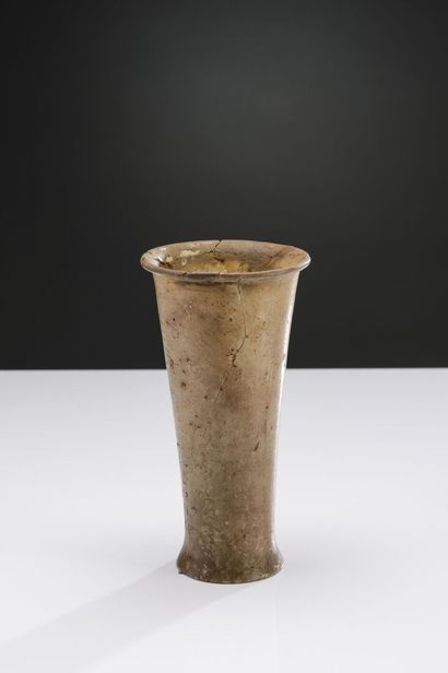 null Large truncated cone-shaped vase with small lip and slightly flared foot.
Alabaster....