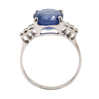 null 18K (750) white gold ring set with an oval-cut sapphire weighing approximately...