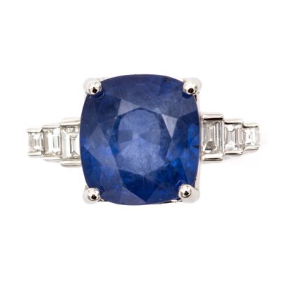 null 18K (750) white gold ring set with an oval-cut sapphire weighing approximately...