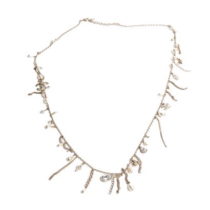 CHANEL CHANEL - Circa 1980, long necklace made of gilded metal chain interspersed...