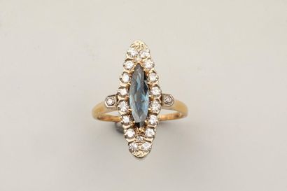 null Marquise ring in 18k yellow gold set with a shuttle-cut sapphire in a diamond...
