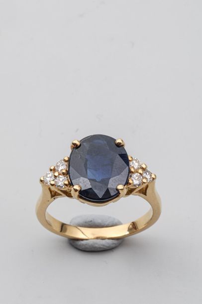 null Ring in 18k yellow gold set with a large sapphire with 6 diamonds on the shoulder...