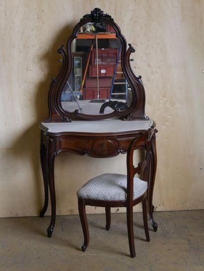 null Moulded mahogany dressing table carved with foliage. The purple mirror with...