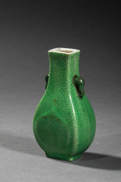 null CHINA, 18th century. Miniature green vase with handles in the shape of stylized...
