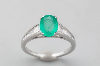 null River" ring in 18k white gold set with an oval-cut emerald (probably from Colombia)...