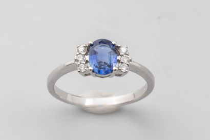 null 18k white gold ring set with a 0.8 carat oval cut sapphire set with 6 modern...