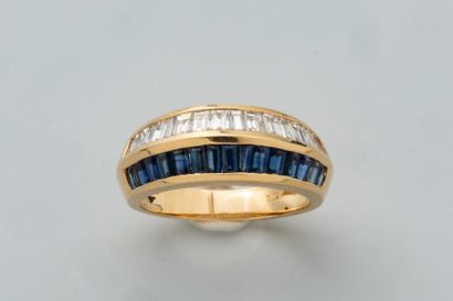 null Dome ring in 18k yellow gold set with 2 lines paved with sapphires and baguette-cut...
