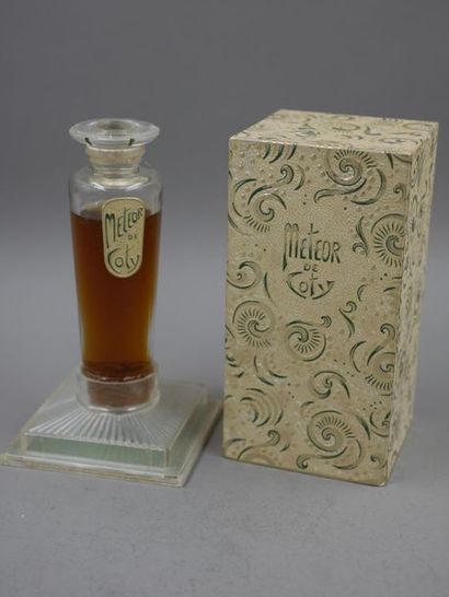 null COTY - Météor - Flared glass bottle, flat cap, label titled "météor de coty"...