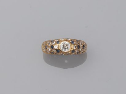 null 18k yellow gold ring paved with diamonds and small emeralds centered with a...