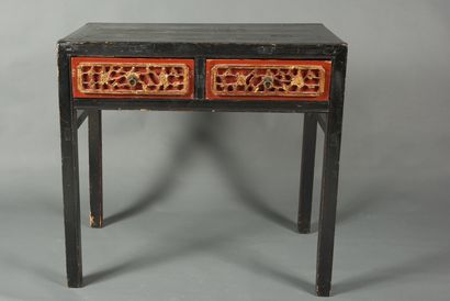 null China, 20th century. Work table opening with two drawers carved with flowers...