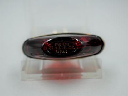 null Guerlain. Samsara. Red glass bottle titled in gold lettering. Perfume extract...