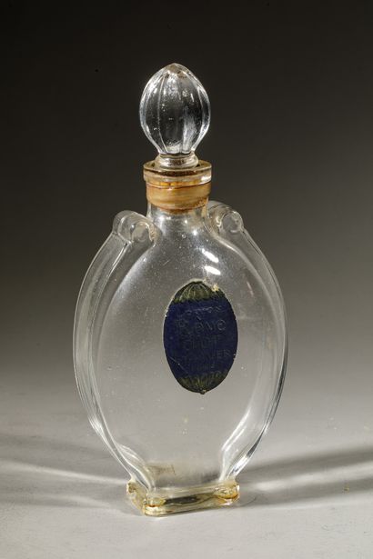 null L.T PIVER " Rêve d'Or " Oval shaped glass bottle on pedestal. Emerized shell-shaped...