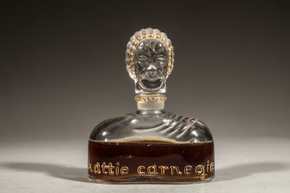 null HATTIE CARNEGIE Bottle in colourless pressed glass enhanced with gold, featuring...