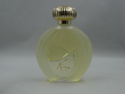 null Nina Ricci. Lalique. Nina. Flacon en verre décor en relief titré en lettre or....