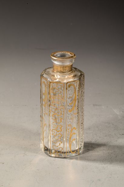 null AHMED SOLIMAN Octagonal glass bottle with Egyptian decoration on each side....