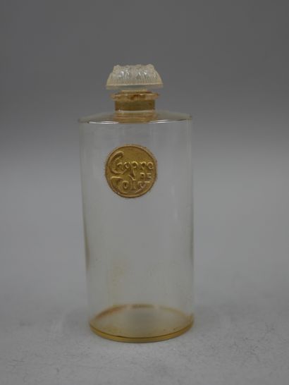 null Coty. Cyprus. Cylindrical glass bottle with an embossed label titled gold-coloured...