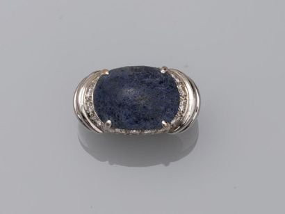 null 18k white gold ring surmounted by a lapis lazuli cabochon, paved with diamonds...