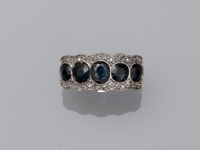 null Antique platinum en bandeau ring surmounted by five sapphires set with diamonds...