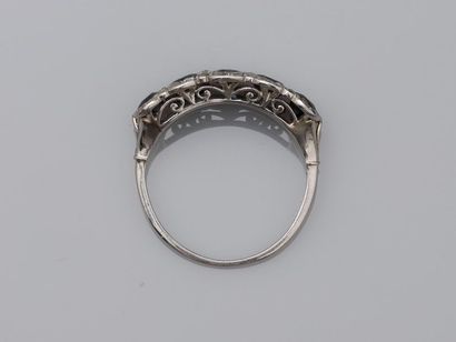 null Antique platinum en bandeau ring surmounted by five sapphires set with diamonds...