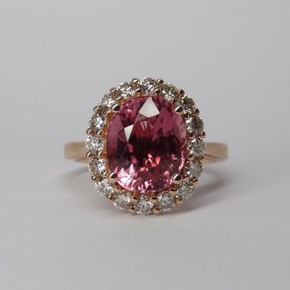 null 18k rose gold ring set with an oval pink tourmaline of about 3.50cts encircled...