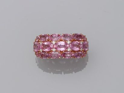 null 18k yellow gold dome ring composed of three lines of oval pink sapphires punctuated...