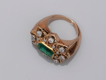 null Flower ring in 18k yellow gold surmounted by an emerald cut emerald in an openworked...