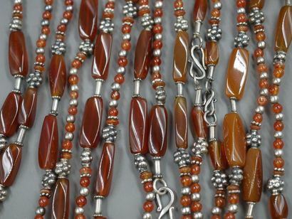 null Lot: Set of five necklaces in silver, silver plated metal and shaded brown beads...