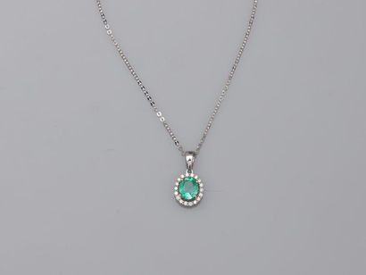 null 18k white gold pendant in the shape of an openwork oval set with an emerald...