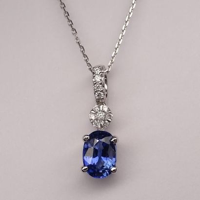 null Pendant in 18k white gold set with an oval sapphire of about 1ct surmounted...