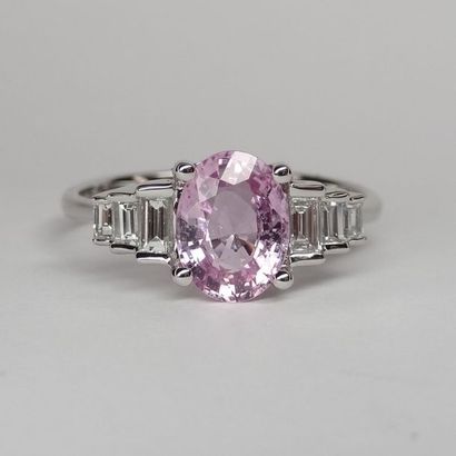null 18k white gold ring set with an oval pink sapphire of approximately 1.30cts...