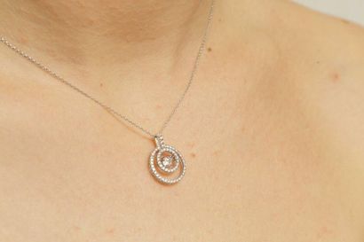 null Pendant Circle in 18k white gold with dancing diamond in its center of about...