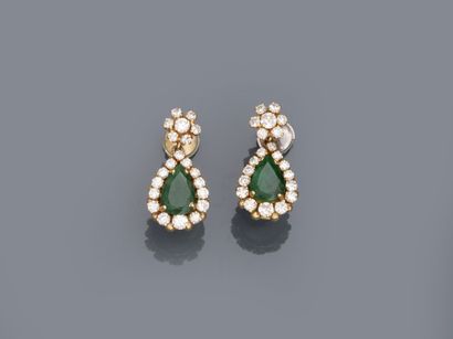 null A pair of 18k yellow gold earrings set with pear-cut emeralds in a diamond setting...