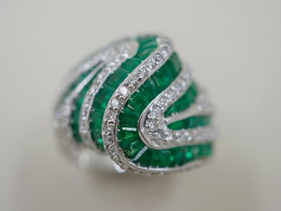 null Ring in 18k white gold made of lines of calibrated emeralds and lines of diamonds...