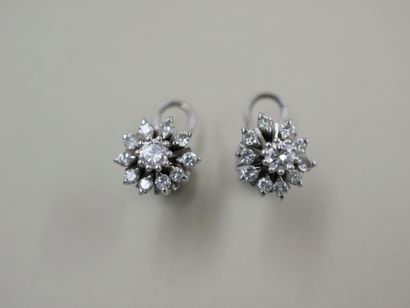 null Pair of 18k white gold flower earrings set with round diamonds, the one in the...