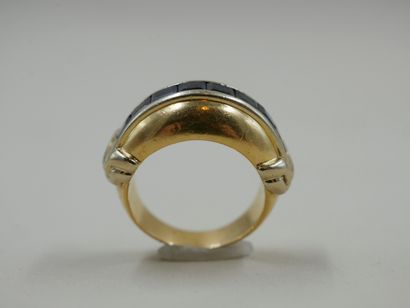 null Helmet ring in 18k yellow gold set with a line of calibrated sapphires with...