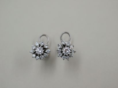 null Pair of 18k white gold flower earrings set with round diamonds, the one in the...