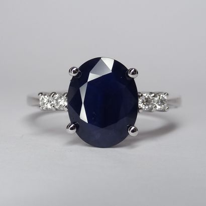 18k white gold ring with an oval sapphire...