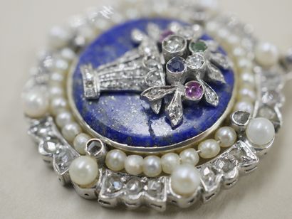 null 18k white gold medallion pendant set with a lapis lazuli plate decorated with...