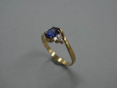 null 18k yellow gold ring with openwork scrolls topped by a 1ct sapphire and three...