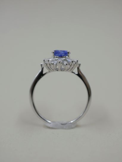null 18k white gold skirt ring set with an oval sapphire weighing approximately 1.20cts...