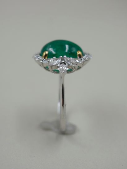 null 18k white gold ring set with an oval cabochon emerald surrounded by brilliant-cut...