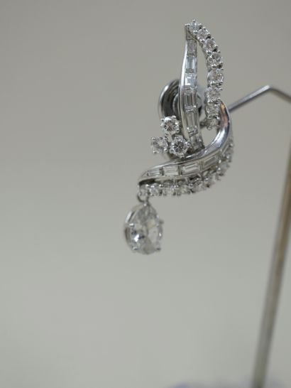 null 
A pair of 18k white gold and platinum ear clips, each set with baguette diamonds...