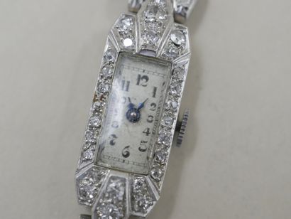 null Lady's watch in platinum, the rectangular case chased with flowers and set with...
