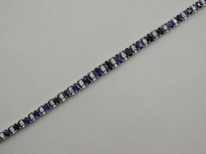 null 18k white gold bracelet set with a line of sapphires alternated with diamonds...