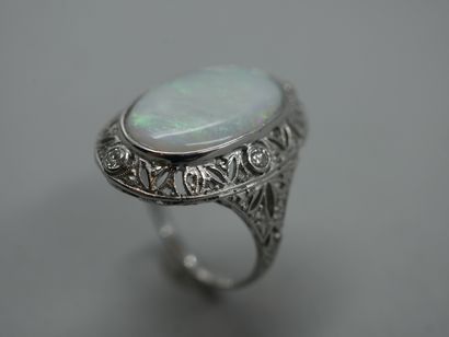 null 18k white gold ring surmounted by an oval opal in an openwork setting set with...