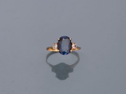 null 18k yellow gold ring set with an oval sapphire and synthetic sapphire doublet...