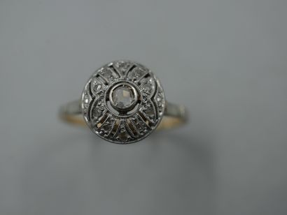 null An 18k yellow and white gold Art Deco ring set with a round openwork diamond...