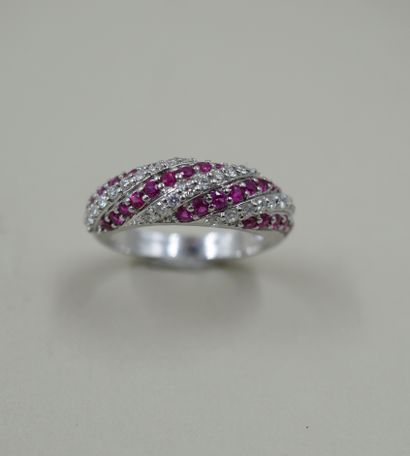 null Band ring in 18k white gold paved with alternating lines of rubies and diamonds...