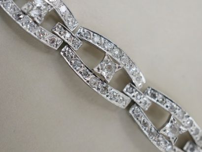 null 18k white gold bracelet composed of oblong links, paved with diamonds and presenting...